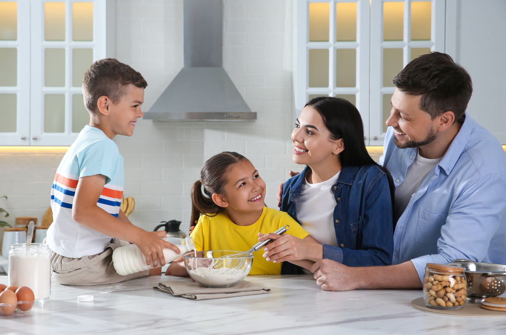 Happy,Family,Cooking,Together,At,Table,In,Kitchen.,Adoption,Concept